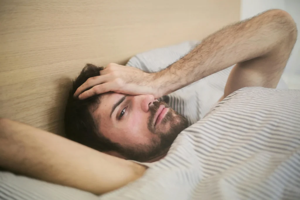 Person waking up tired even after sleeping well in the morning